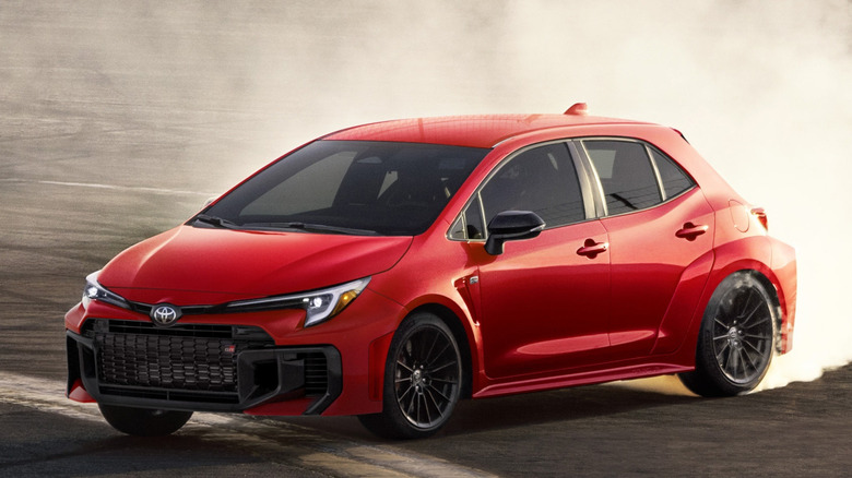 Front 3/4 view of 2025 Toyota GR Corolla sliding on track