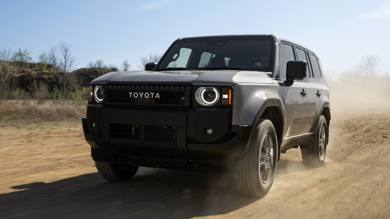 Toyota Land Cruiser driving down a dirt road