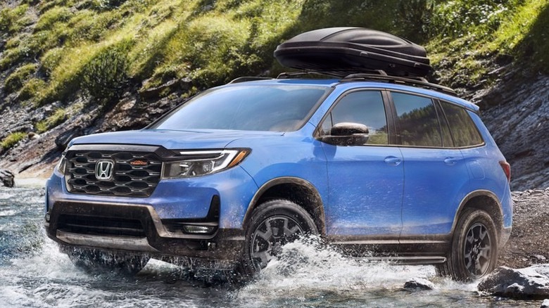 Honda Passport driving through a river