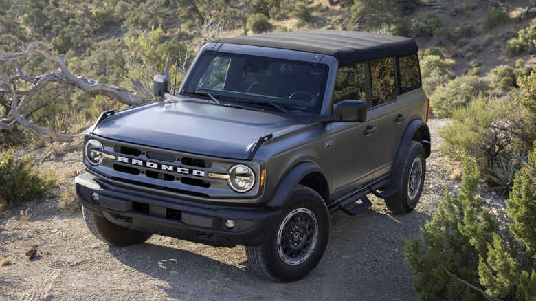 Convertible Ford Bronco parked on a dirt road