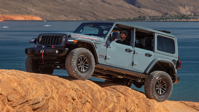 Jeep Wrangler off-roading up a desert hill