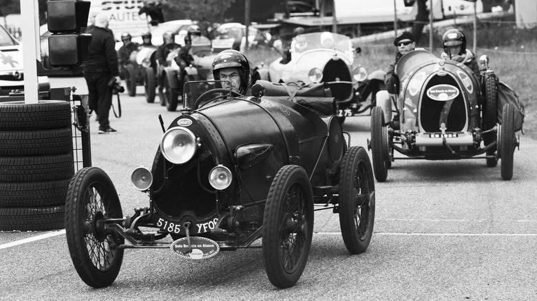 Antique Bugatti race cars on track