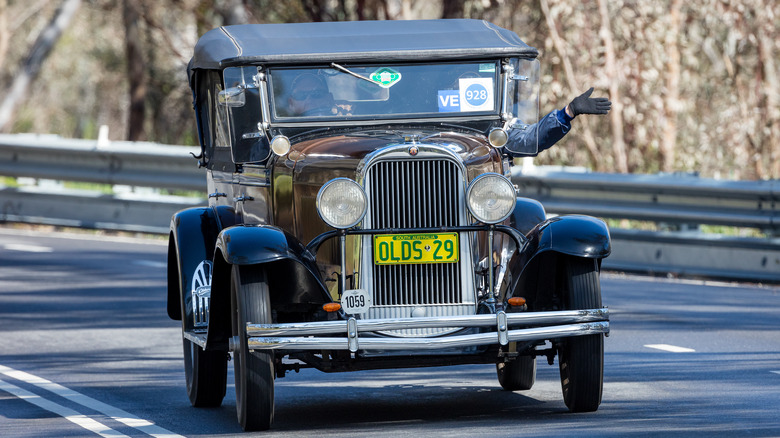 A 1929 Oldsmobile driving on a road