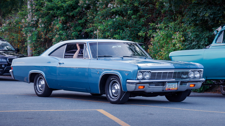 A 1966 Chevy Impala entering a parking lot