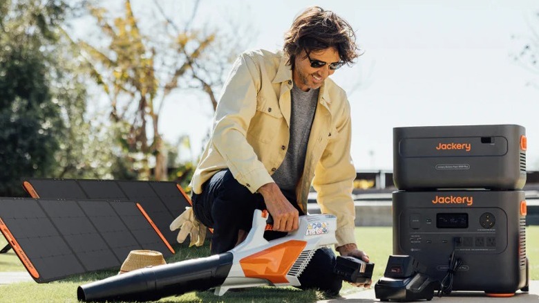 Jackery power station with solar panels and leaf blower