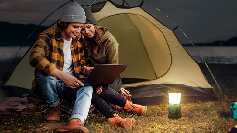 Lepro lantern being used by camping couple