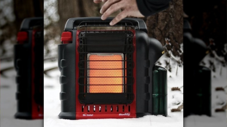 Person warming hands on Mr. Heater Portable Buddy Heater