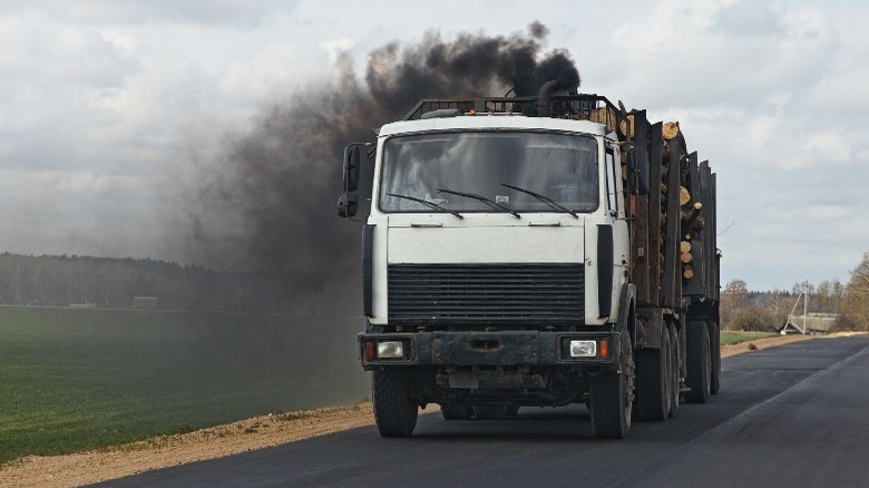 Black exhaust smoke from a diesel timber truck