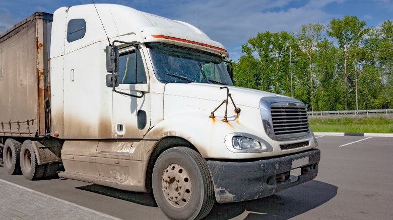 Dirty truck parked on the road