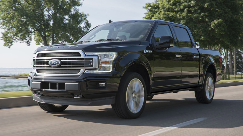 Black 2019 Ford F-150 Limited with the 3.5L EcoBoost engine driving down the road