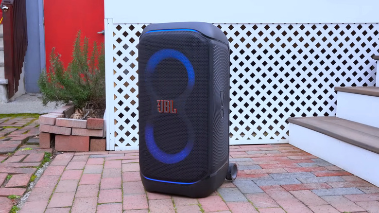 Speaker sitting outside of someone's house with lights on