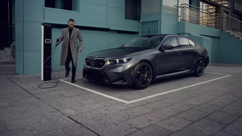 A V8 hybrid 2025 BMW M5 parked at a charging station