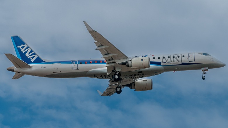 A regional jet in flight using Mitsubishi engines.