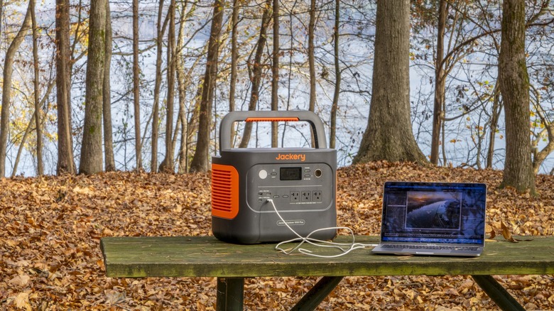 Jackery power station on picnic table with laptop attached