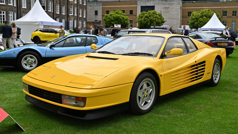 Yellow Ferrari Testarossa parked at car show