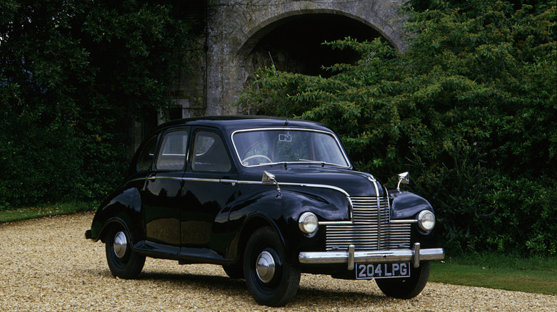 A black Jowett Javelin parked in the forest