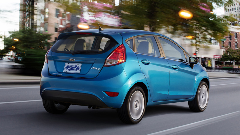 A blue Ford Fiesta driving on the street