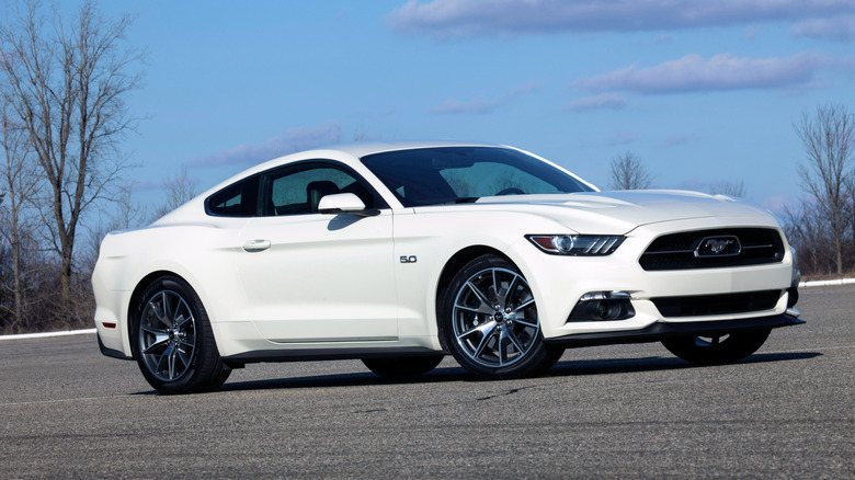 A white Ford Mustang parked on the road