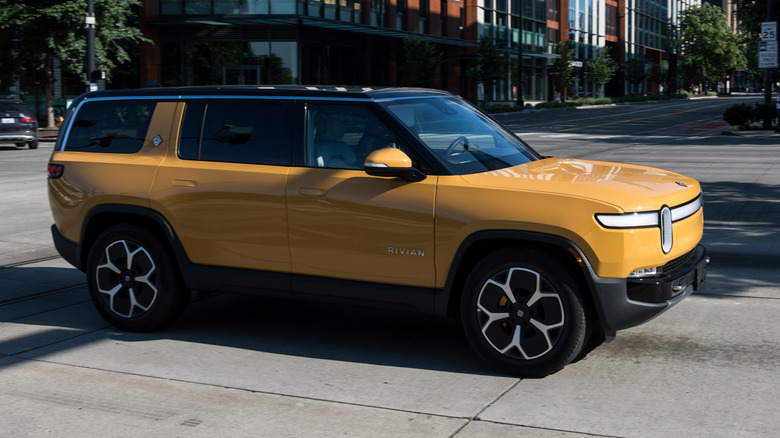 Yellow 2023 Rivian R1S on an urban road