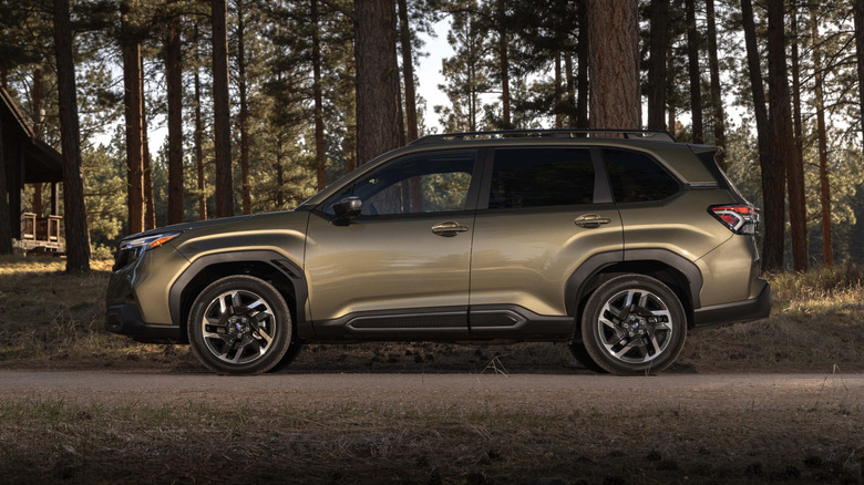 2025 Subaru Forester driving on a wooded road