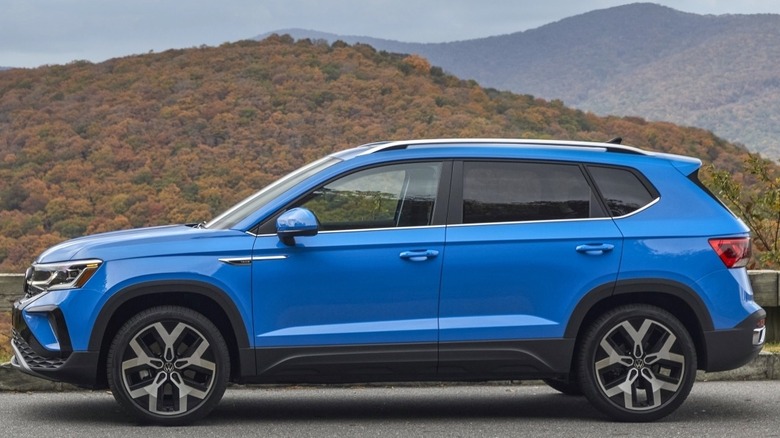 Blue Volkswagen Taos on a paved rural road