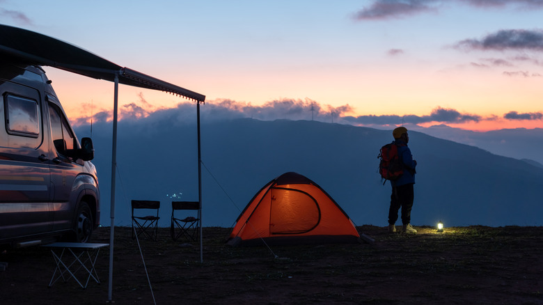 Camper watching sunrise