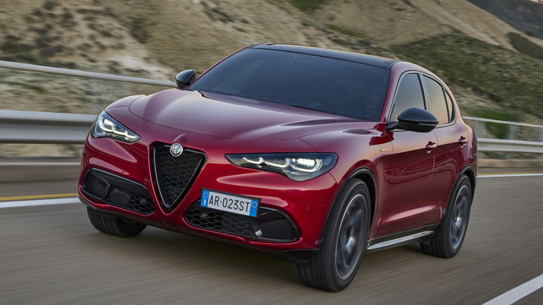 red 2024 Alfa Romeo Stelvio driving on road