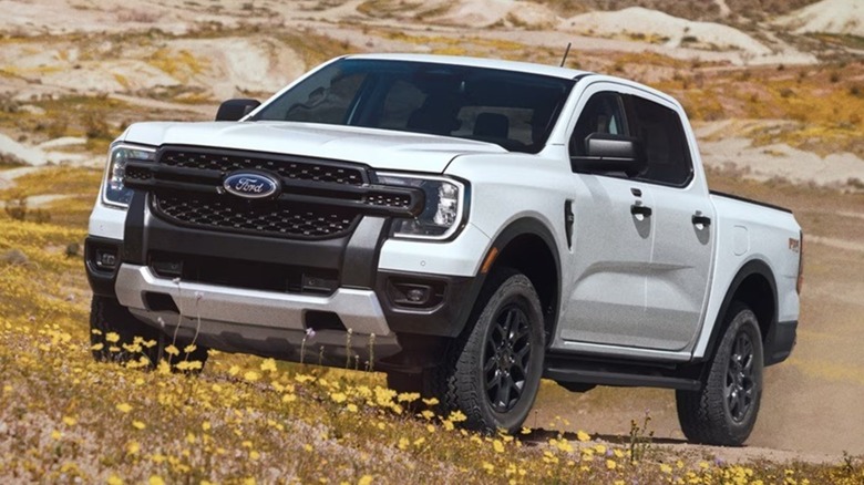 white 2025 Ford Ranger driving in field with wildflowers