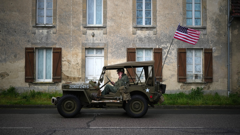 Army Jeep being driven through street