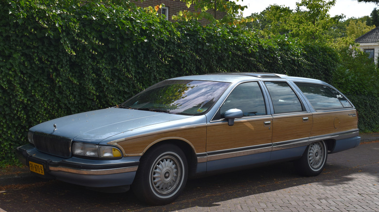 A Buick Roadmaster Estate Wagon parked beside a vine-covered wall