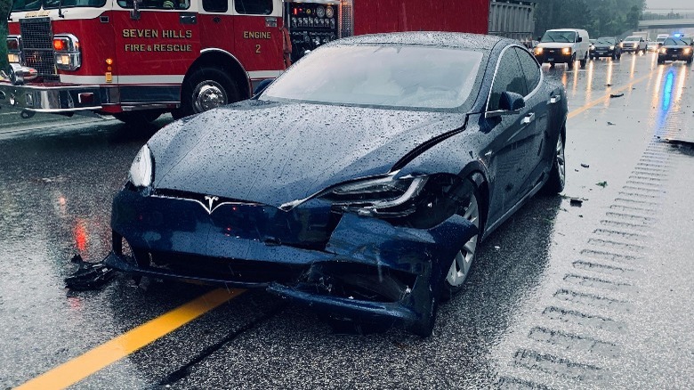 Tesla with oulled bumper from an accident