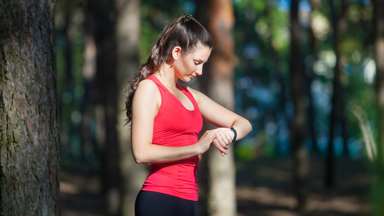 runner looking at fitness tracker on wrist