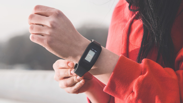 runner putting on fitness tracker