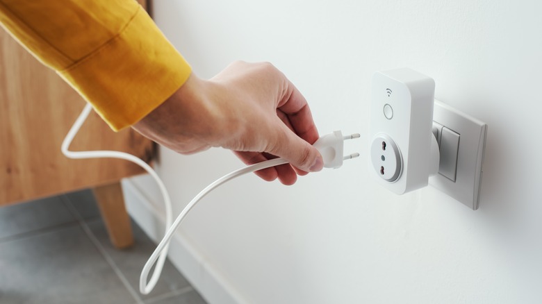 person using a smart plug