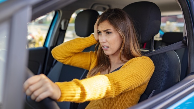 A frustrated driver experiencing car problems.