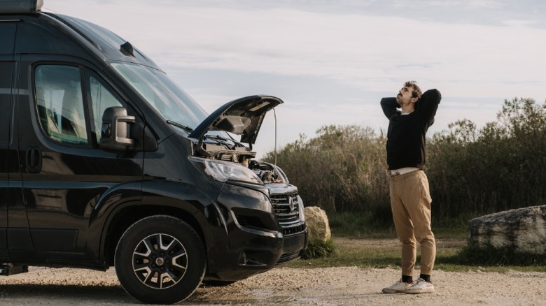 A frustrated person outside of a van