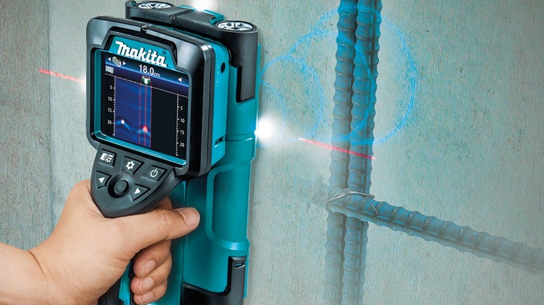 Using the Makita scanner to find objects hidden in a wall.