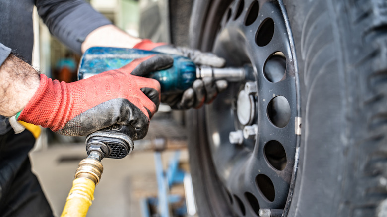 Person using an impact wrench