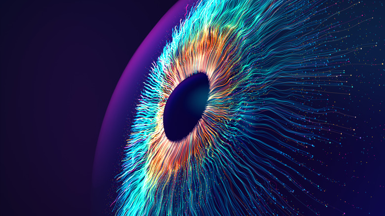 Digitally-generated image of multicolored particles forming eye shape against black background