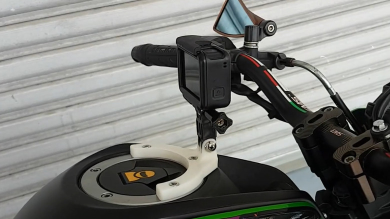 GoPro mounted on a motorcycle fuel tank with printed bracket