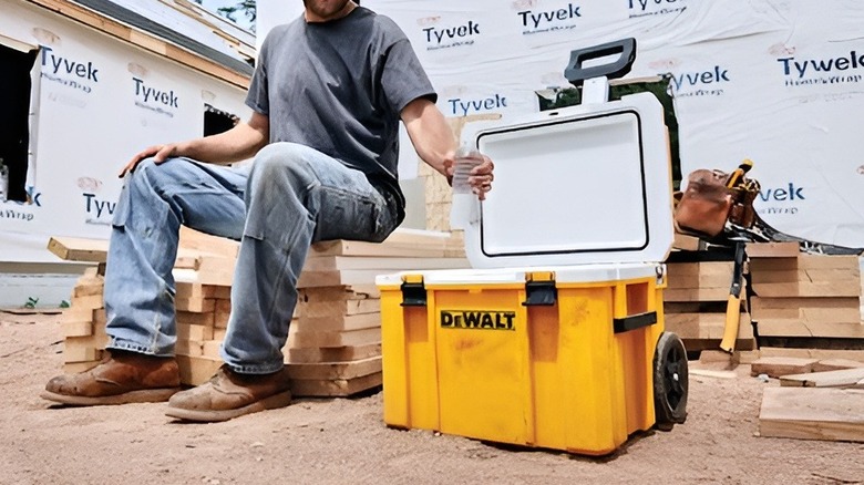 Man opening DeWalt cooler at jobsite