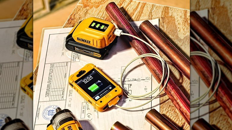 DeWalt charger powering up iPhone on construction table