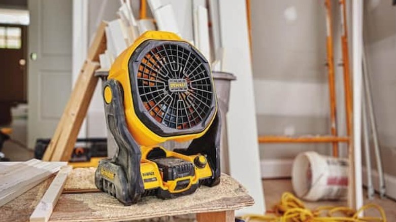 20V Max 11 Corded/Cordless Jobsite Fan sitting on bench in worksite