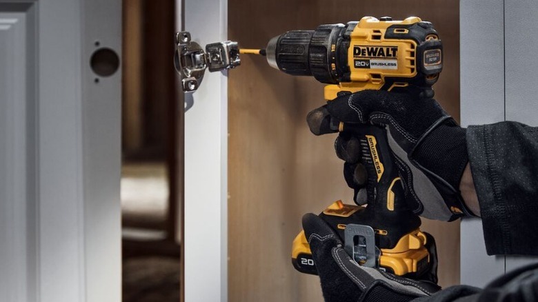 Person using 20V MAX Brushless Cordless ½ Drill/Driver on door latch