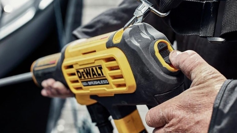 Person adjusting dial on DeWalt 60V Max Power Washer