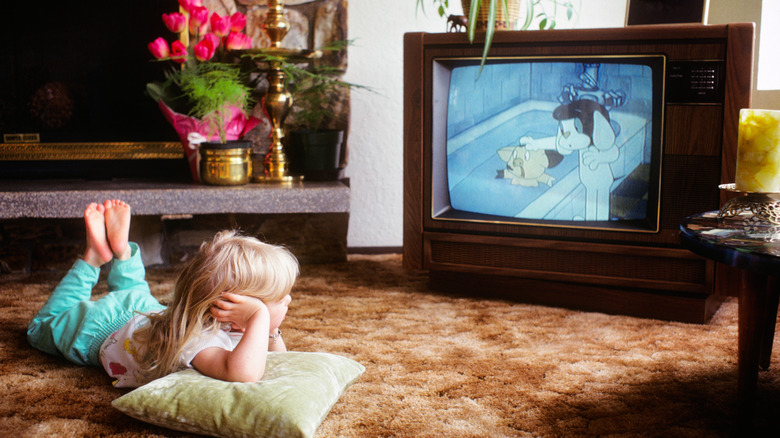 little girl watching cartoons on a CRT TV