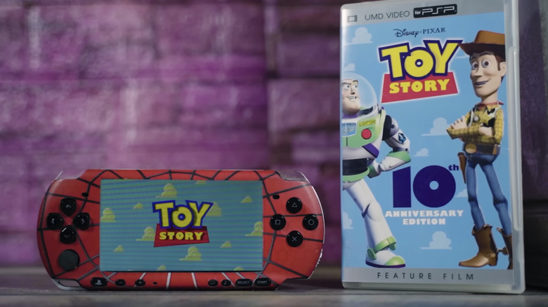 Sony PlayStation Portable playing a "Toy Story" UMD next to the movie's case