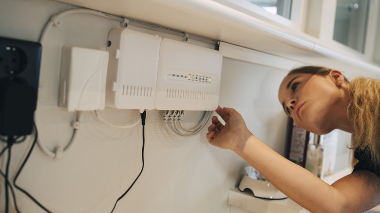 Woman working on router.