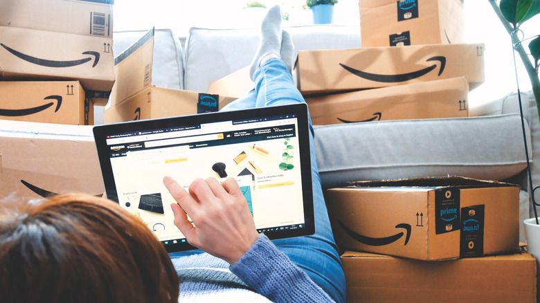 person shopping on amazon surrounded by packages