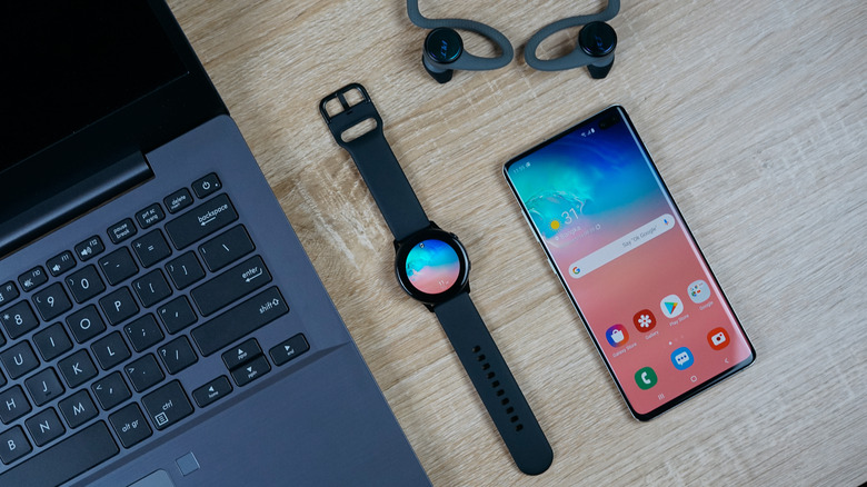Android phone with laptop, smartwatch, and earbuds